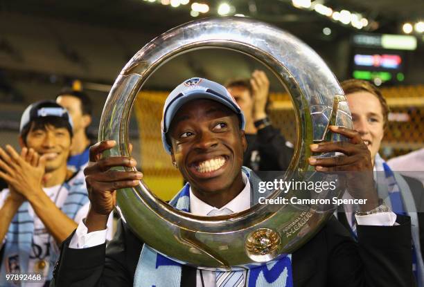 Kofi Danning of Sydney FC poses with the trophy after winning the A-League Grand Final match between the Melbourne Victory and Sydney FC at Etihad...