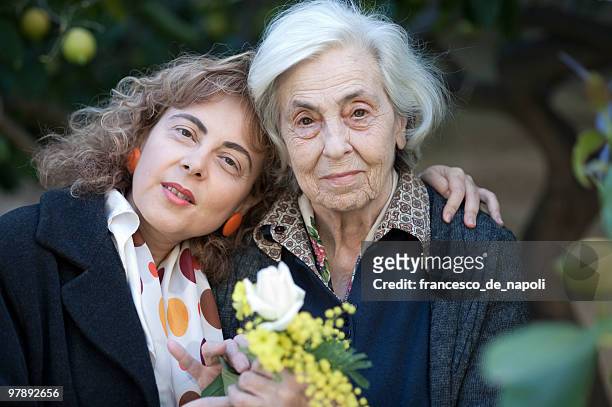 happy mother and daughter - terza età stock pictures, royalty-free photos & images