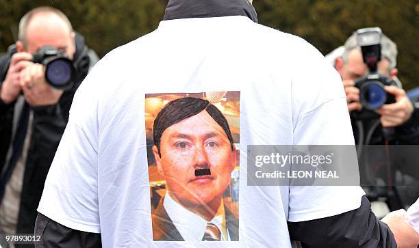 Strike supporter wears a shirt depicting British Airways Chief Executive Willie Walsh as Adolf Hitler at a really near terminal 4 at Heathrow airport...