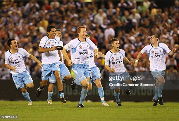 Sydney FC players celebrate winning the penalty shootout in extra time during the A-League Grand Final match between the Melbourne Victory and Sydney...