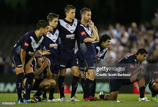 Victory players look on during the penalty shootout in extra time during the A-League Grand Final match between the Melbourne Victory and Sydney FC...