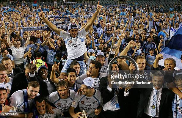 Sydney FC players pose for a team shot with Sydney fans after winning the A-League Grand Final match between the Melbourne Victory and Sydney FC at...