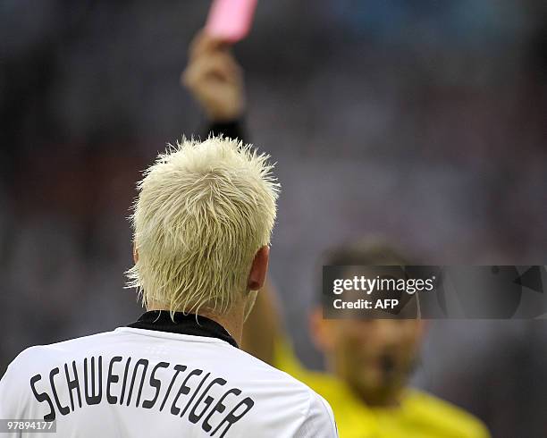 German midfielder Bastian Schweinsteiger is given a red card by Belgian referee Frank De Bleeckere during the Euro 2008 Championships Group B...