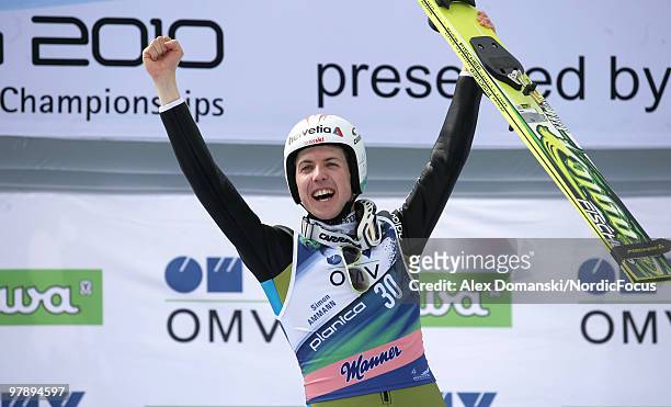 Simon Ammann of Switzerland celebrates on the podium after winning the individual event of the Ski jumping World Championships on March 20, 2010 in...