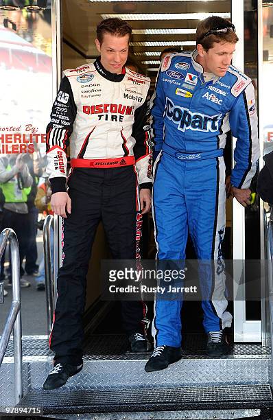 Carl Edwards , driver of the COPART Ford, and Brad Keselowski, driver of the Discount Tire Dodge, walk out of the NASCAR hauler at Bristol Motor...