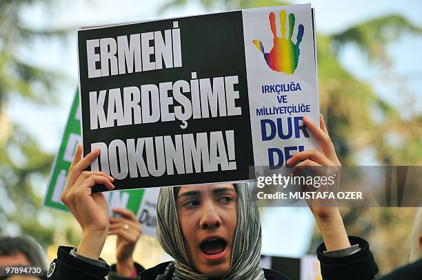 Turkish demonstrator shouts slogans and holds a placard, reading: "Don't touch my Armenian brother," during a demonsration on March 20, 2010 in...