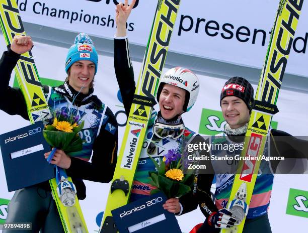 Gregor Schlierenzauer of Austria takes 2th place, Simon Ammann of Switzerland takes 1st place and Anders Jacobsen of Norway takes 3rd during the FIS...