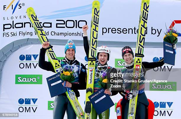 Gregor Schlierenzauer of Austria takes 2th place, Simon Ammann of Switzerland takes 1st place and Anders Jacobsen of Norway takes 3rd during the FIS...
