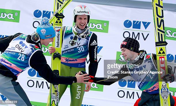 Gregor Schlierenzauer of Austria takes 2th place, Simon Ammann of Switzerland takes 1st place and Anders Jacobsen of Norway takes 3rd during the FIS...
