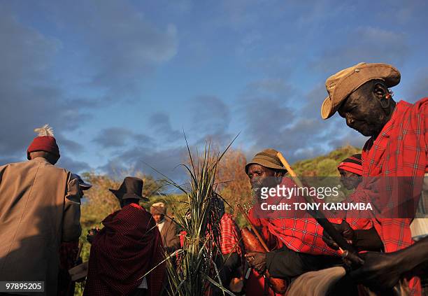 An Endorois elder spits traditional brew onto palm fronds on March 20, 2010 by the shores of Lake Bogoria, approximately 300 kilometres nothwest of...