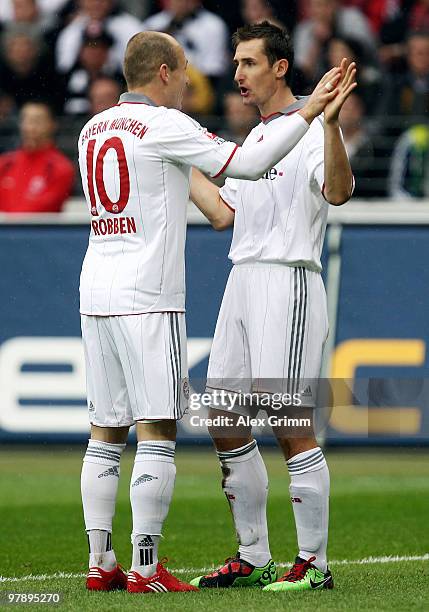 Miroslav Klose of Muenchen celebrates scoring his team's first goal with team mate Arjen Robben during the Bundesliga match between Eintracht...