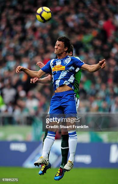 Sebastian Boenisch of Bremen is challenged by Roman Prokoph of Bochum during the Bundesliga match between SV Werder Bremen and VfL Bochum at Weser...