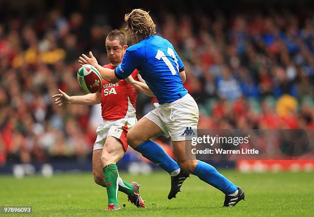 Shane Williams of Wales chips the ball past Mirco Bergamasco of Italy during the RBS Six Nations Championship between Wales and Italy at Millennium...