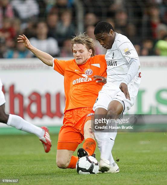 Cedrick Makiadi of Freiburg battles for the ball with Eugen Polanski of Mainz during the Bundesliga match between SC Freiburg and FSV Mainz 05 at...