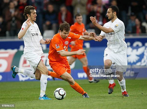 Julian Schuster of Freiburg and Oemer Toprak of Freiburg battles for the ball with Andreas Ivanschitz of Mainz during the Bundesliga match between SC...