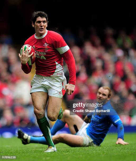 James Hook of Wales breaks through the tackle of Gonzalo Garcia of Italy during the RBS Six Nations match between Wales and Italy at Millennium...