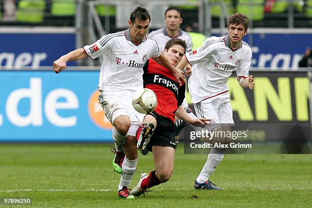 Pirmin Schwegler of Frankfurt is challenged by Miroslav Klose and Thomas Mueller of Muenchen during the Bundesliga match between Eintracht Frankfurt...