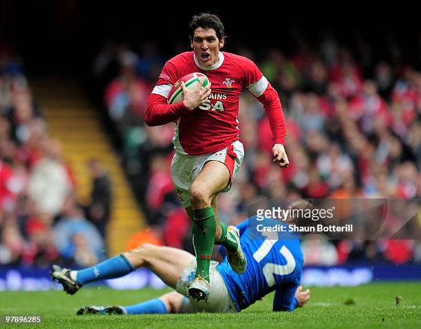 James Hook of Wales breaks through the tackle of Gonzalo Garcia of Italy during the RBS Six Nations match between Wales and Italy at Millennium...