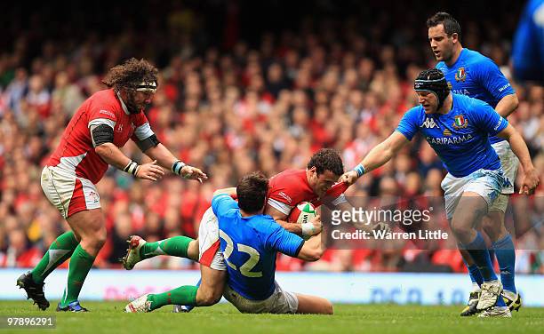 Jamie Roberts of Wales is tackled by Matteo Pratichetti of Italy during the RBS Six Nations Championship between Wales and Italy at Millennium...