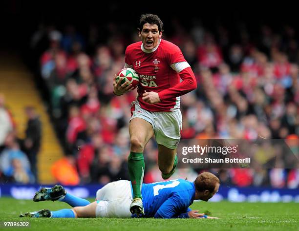 James Hook of Wales breaks through the tackle of Gonzalo Garcia of Italy during the RBS Six Nations match between Wales and Italy at Millennium...