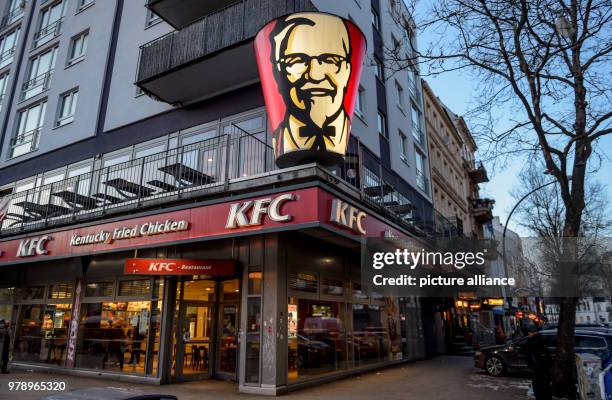 March 2018, Germany, Hamburg: The restaurant of the fast food chain Kentucky Fried Chicken by the Hamburg Reeperbahn is illuminated by outdoor...