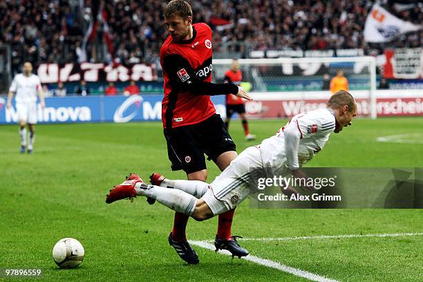 Arjen Robben of Muenchen is challenged by Marco Russ of Frankfurt during the Bundesliga match between Eintracht Frankfurt and Bayern Muenchen at the...