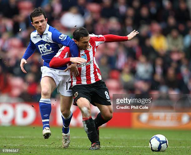 Steed Malbranque of Sunderland is tackled by Barry Ferguson of Birmingham City during the Barclays Premier League match between Sunderland and...