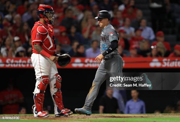 Jake Lamb scores on an RBI double hit by David Peralta of the Arizona Diamondbacks as Martin Maldonado of the Los Angeles Angels of Anaheim looks on...