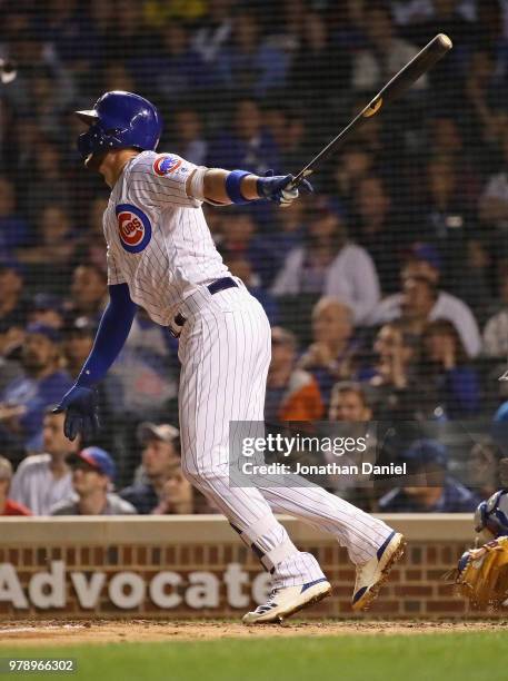 Kris Bryant of the Chicago Cubs hits a triple in the 10th inning against the Los Angeles Dodgers at Wrigley Field on June 19, 2018 in Chicago,...