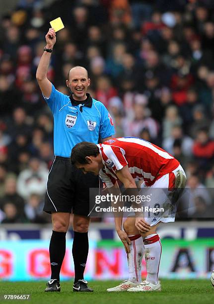 Referee Mike Dean laughs as he gives Dean Whitehead of Stoke his first yellow card in the first half of the Barclays Premiership match between Stoke...