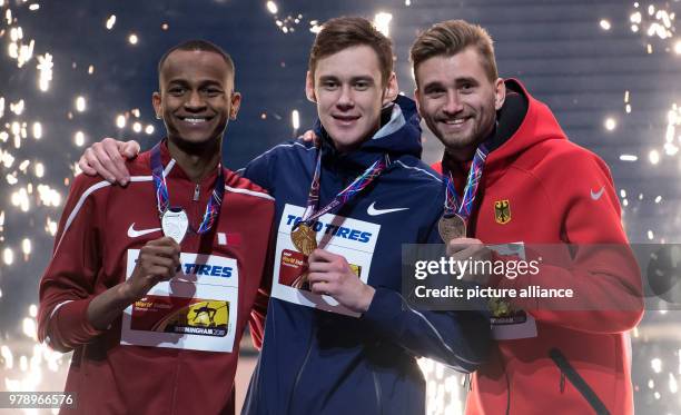 March 2018, Great Britain, Birmingham: IAAF World Indoor Championships in Athletics: Mutaz Essa Barshim of Qatar, Danil Lysenko of Russia and Mateusz...