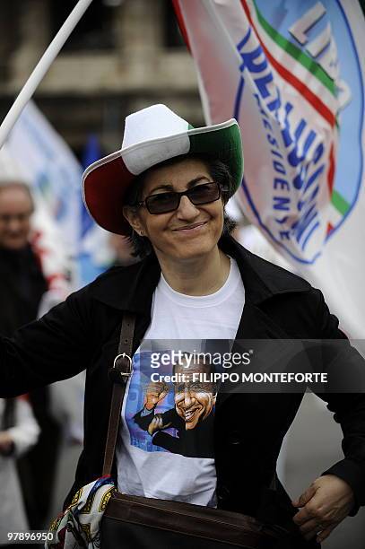 Supporter of Italian Prime Minister and President of the "Popolo della Liberta" party Silvio Berlusconi wears a tee-shirt showing Berlusconi during a...