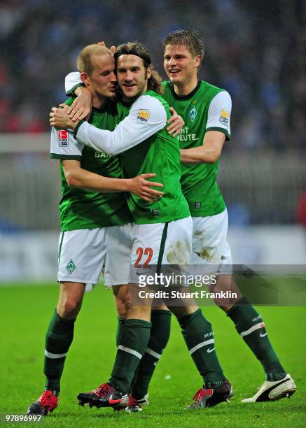 Torsten Frings of Bremen celebrates scoring his team's third goal with Sebastian Prödl and Petri Pasanen during the Bundesliga match between SV...