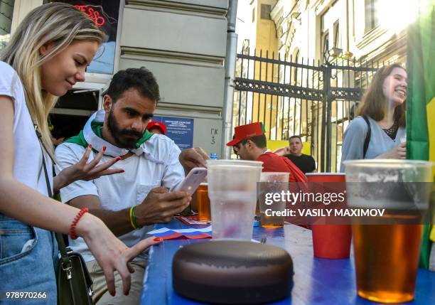 Football fans relax and drink beer in central Moscow on June 18 during the Russia 2018 World Cup. - While Russia is ranked 14th in the world in terms...