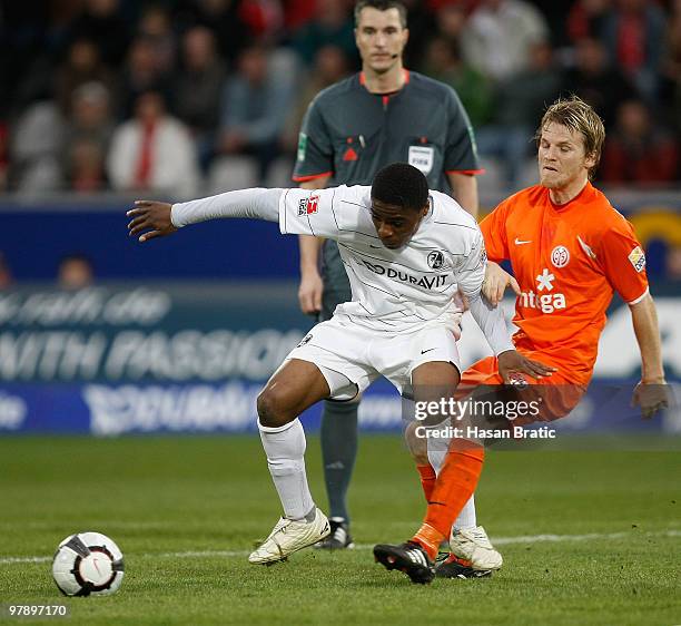 Cedrick Makiadi of Freiburg battles for the ball with Eugen Polanski of Mainz during the Bundesliga match between SC Freiburg and FSV Mainz 05 at...