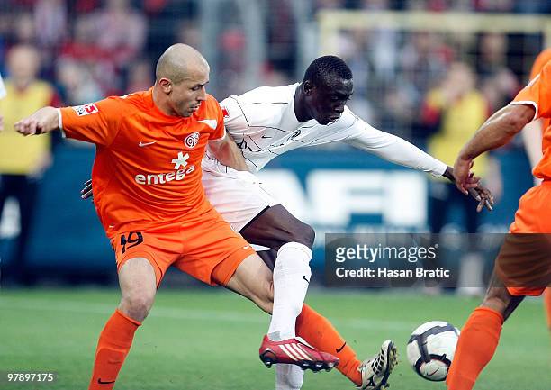 Papiss Cisse of Freiburg battles for the ball with Elkin Soto of Mainz during the Bundesliga match between SC Freiburg and FSV Mainz 05 at Badenova...