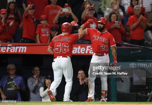 Chris Young congratulates Kole Calhoun of the Los Angeles Angels of Anaheim after his solo homerun during the sixth inning of a game against the...