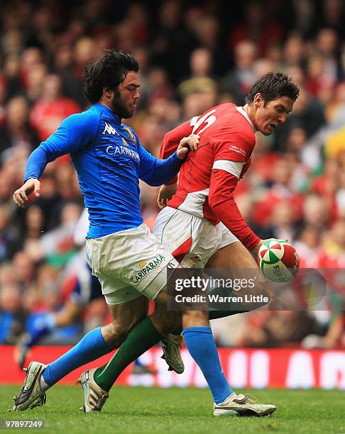 James Hook of Wales tangles with Luke McLean of Italy during the RBS Six Nations Championship match between Wales and Italy at Millennium Stadium on...
