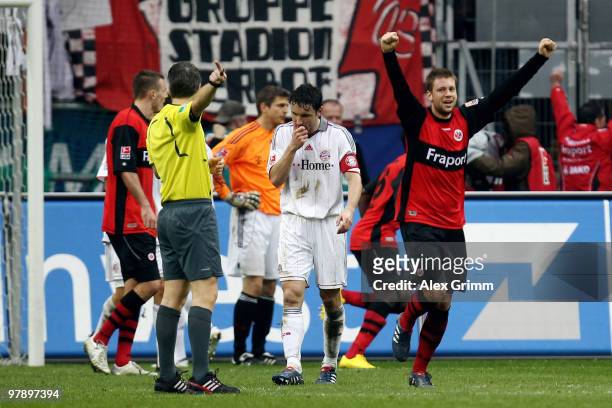 Mark van Bommel of Muenchen reacts as Marco Russ of Frankfurt celebrates during the Bundesliga match between Eintracht Frankfurt and Bayern Muenchen...