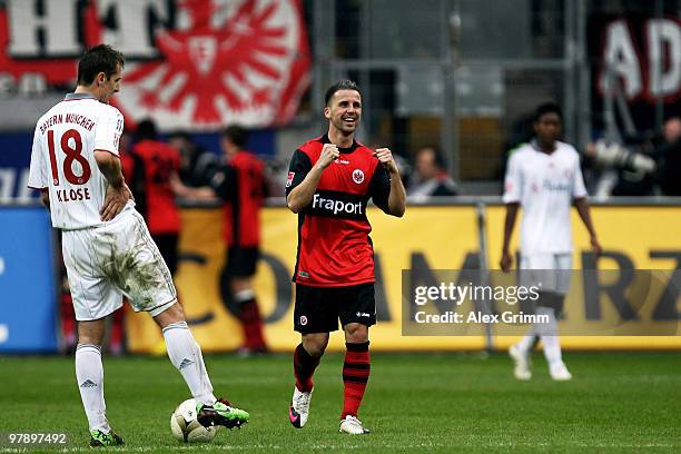 Benjamin Koehler of Frankfurt celebrates as Miroslav Klose of Muenchen looks dejected during the Bundesliga match between Eintracht Frankfurt and...