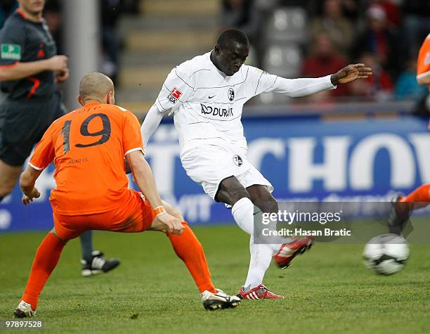 Papiss Cisse of Freiburg battles for the ball with Elkin Soto of Mainz during the Bundesliga match between SC Freiburg and FSV Mainz 05 at Badenova...