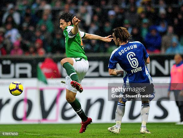 Claudio Pizarro of Bremen is challenged by Christian Fuchs of Bochum during the Bundesliga match between SV Werder Bremen and VfL Bochum at Weser...