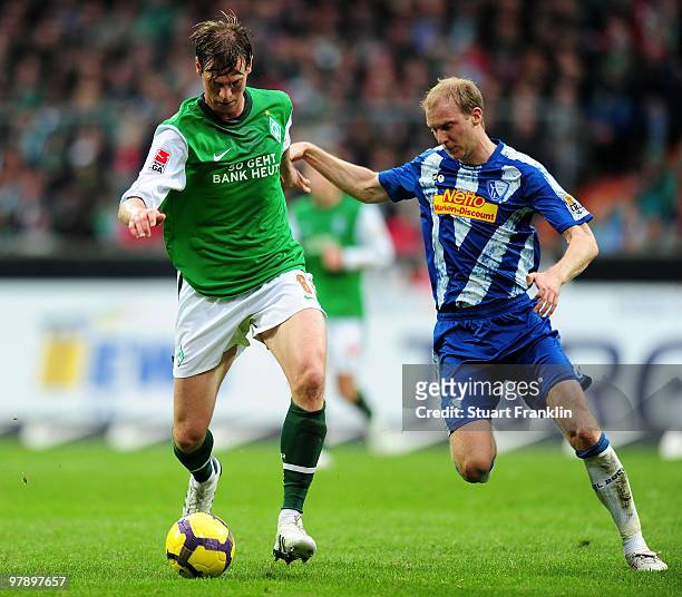 Tim Borowski of Bremen is challenged by Andreas Johansson of Bochum during the Bundesliga match between SV Werder Bremen and VfL Bochum at Weser...