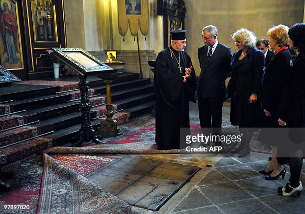 Britain's Prince Charles , flanked by his wife Camilla, Duchess of Cornwall listens to Czech priest Jaroslav Suvarsky during their visit of the crypt...