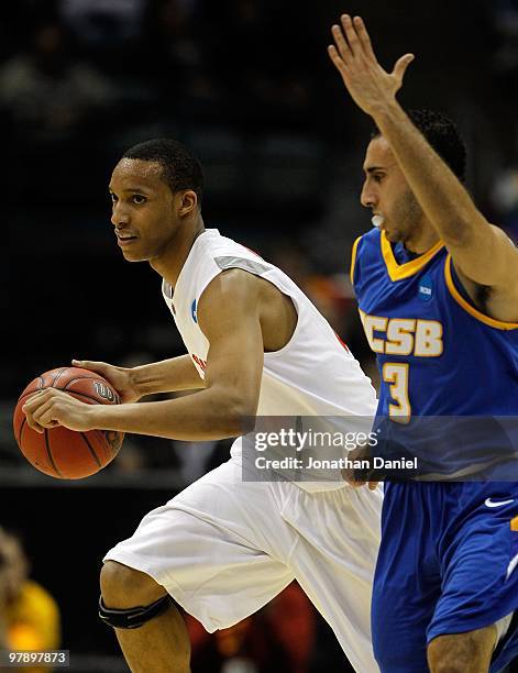 Evan Turner of the Ohio State Buckeyes moves the ball against Jordan Weiner of the UC Santa Barbara Gauchos during the first round of the 2010 NCAA...
