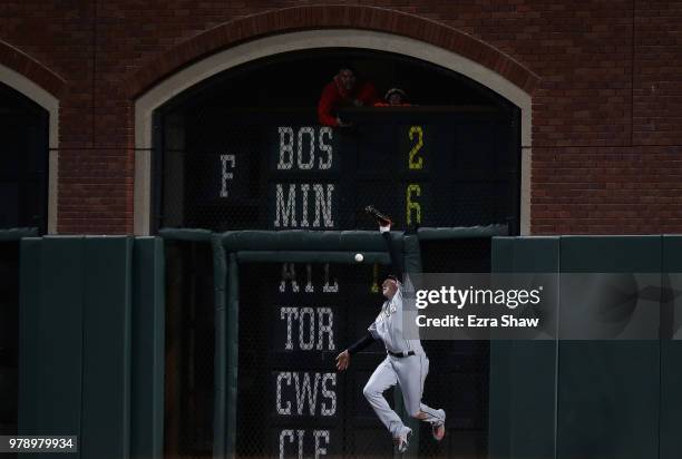 Brian Anderson of the Miami Marlins can not catch a ball hit by Alen Hanson of the San Francisco Giants in the fifth inning at AT&T Park on June 19,...