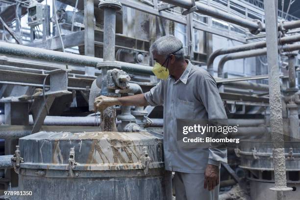 An employee checks slurry being mixed at the HSIL Ltd. Factory in Bahadurgarh, Haryana, India, on Monday, June 11, 2018. Indian Prime Minister...