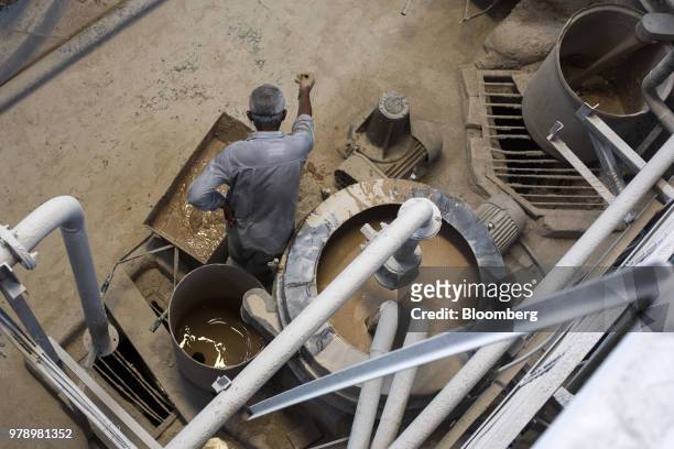 An employee checks slurry being mixed at the HSIL Ltd. Factory in Bahadurgarh, Haryana, India, on Monday, June 11, 2018. Indian Prime Minister...