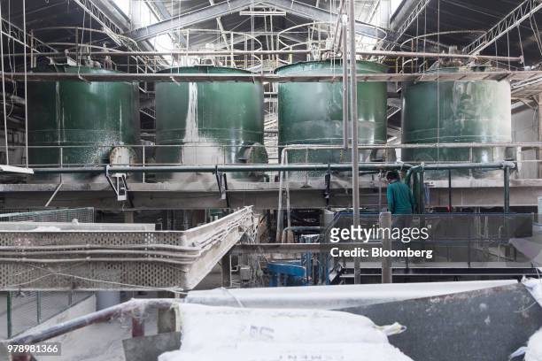 An employee monitors the mixing of raw materials at the HSIL Ltd. Factory in Bahadurgarh, Haryana, India, on Monday, June 11, 2018. Indian Prime...