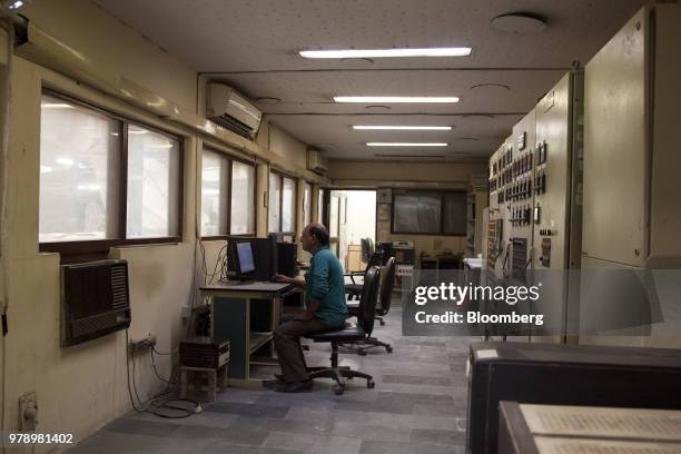 An employee observes the firing of a kiln in a control center at the HSIL Ltd. Factory in Bahadurgarh, Haryana, India, on Monday, June 11, 2018....